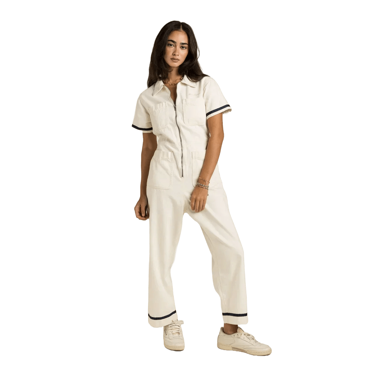 Sendero Dolly Jumpsuit in soft natural cotton ecru with navy tape accents and embroidered cream logo on chest pocket.