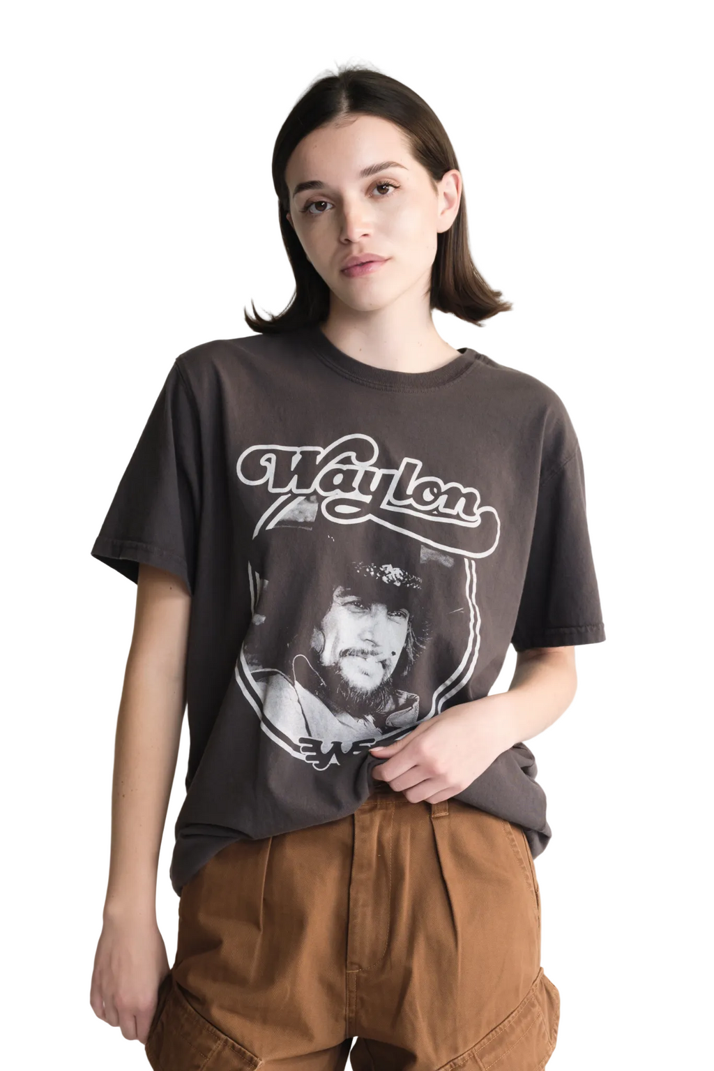 Person wearing a t-shirt with a graphic design on a plain background