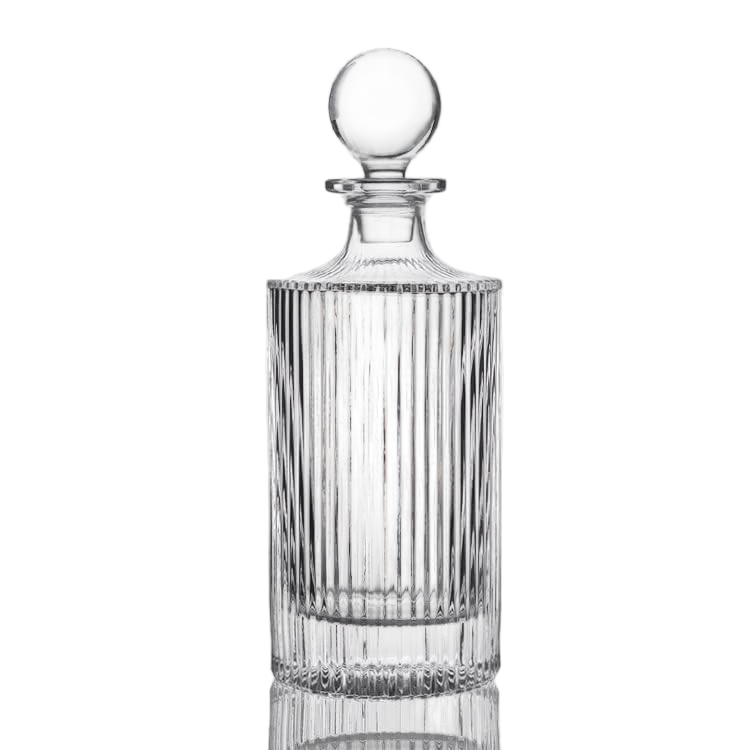 Clear glass decanter with a spherical stopper on a white background