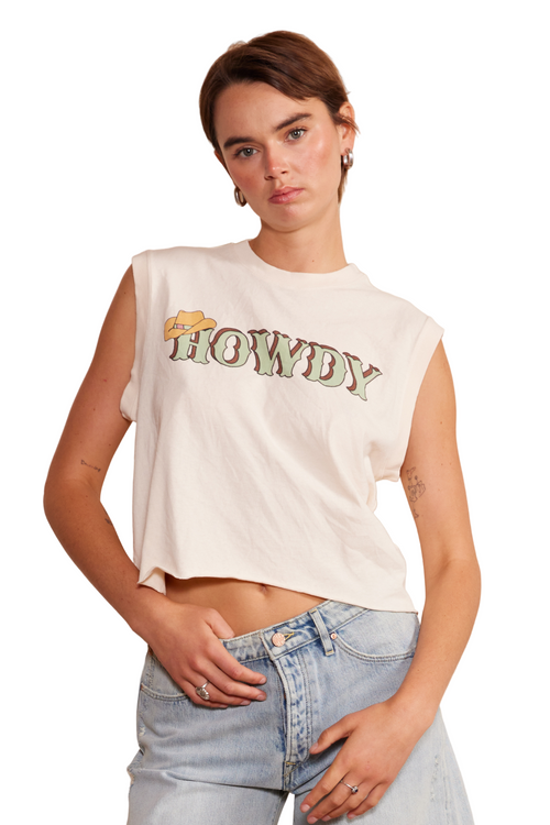 Woman wearing a white 'Howdy' t-shirt and denim shorts against a white background