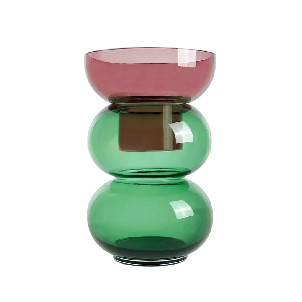 Glass vase with pink top and green bottom on a white background