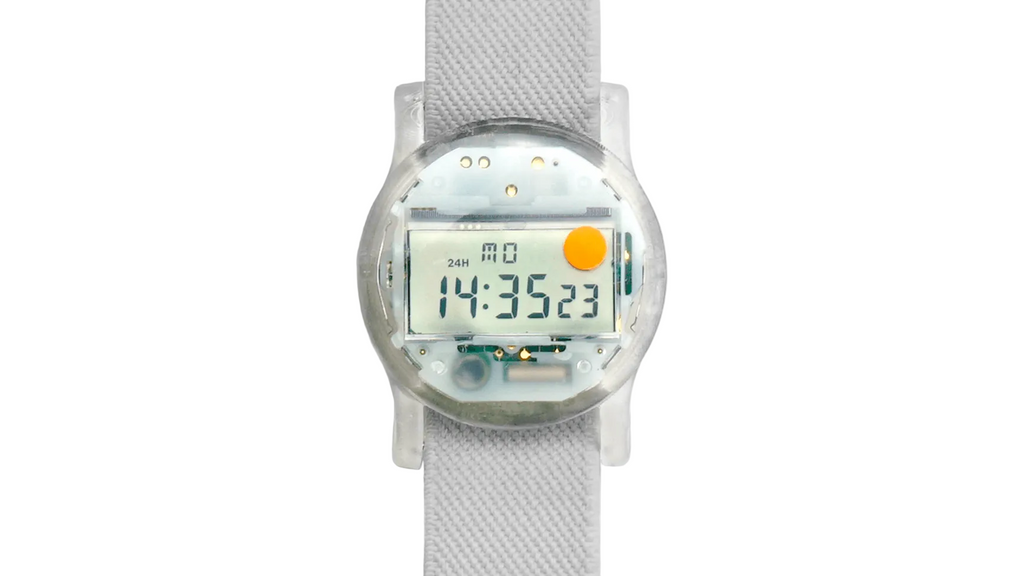 Digital watch with a clear face on a white strap against a white background