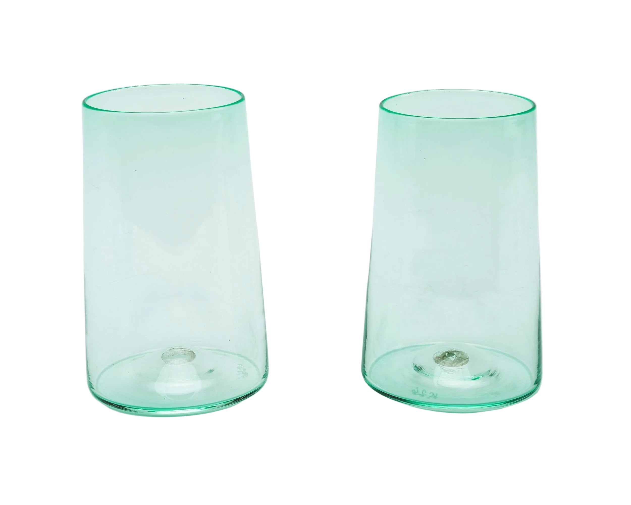 Two green glass tumblers on a white background