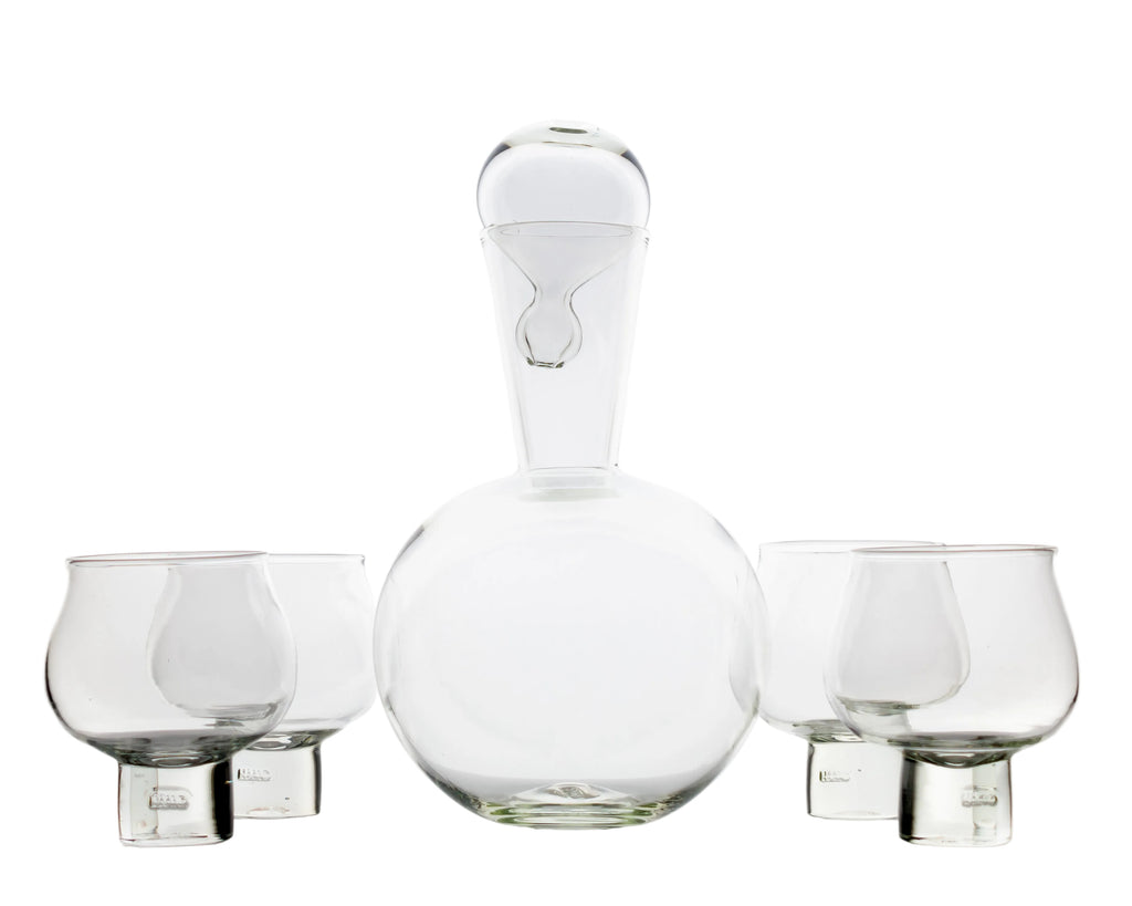 Set of clear glass decanter and tumblers on a white background