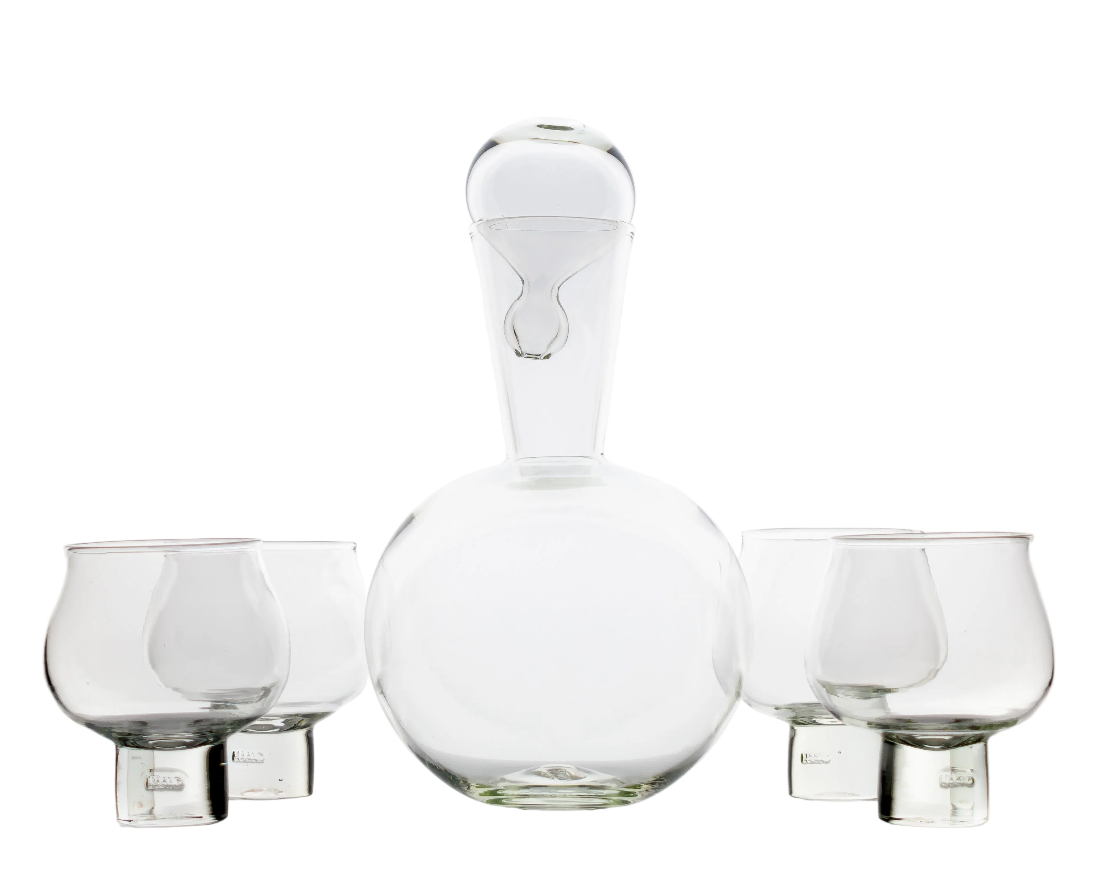 Set of clear glass decanter and tumblers on a white background