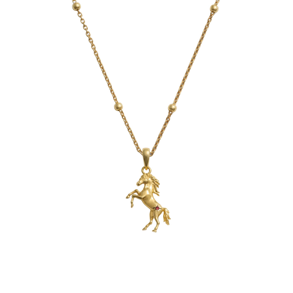 Gold horse pendant necklace on a white background