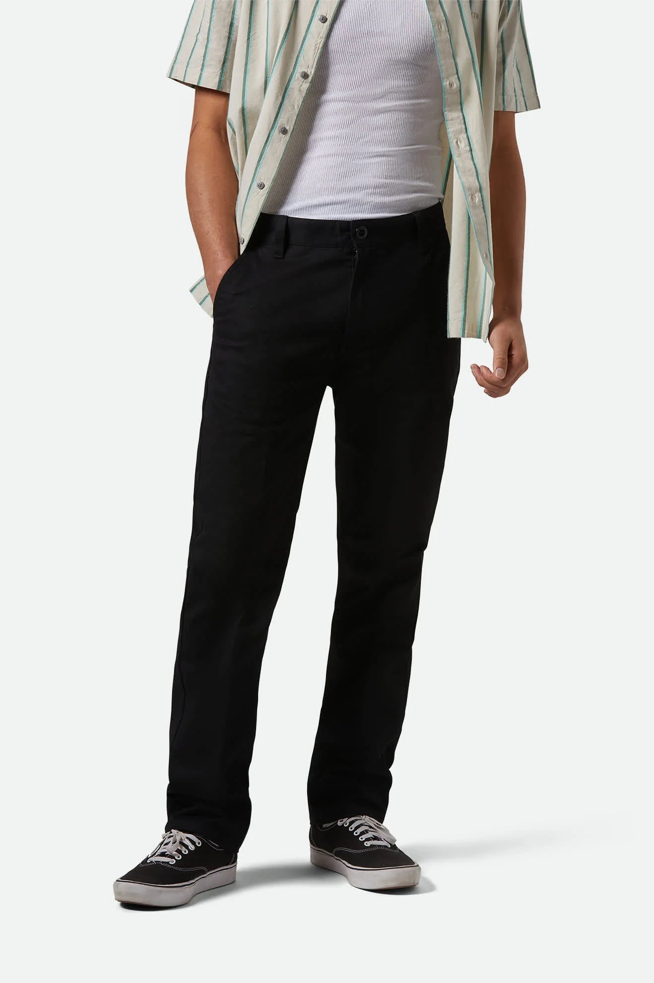 Model wearing Brixton Choice Chinos straight-leg pants in durable stretch twill, medium rise waist.