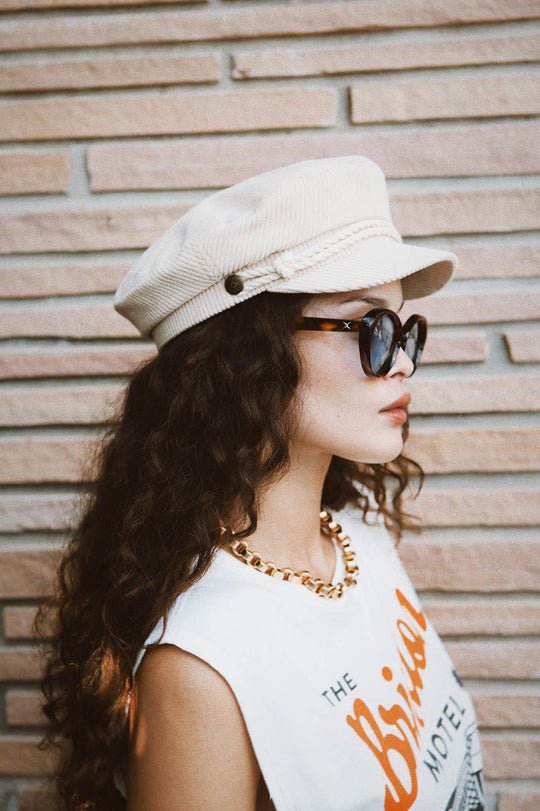 Side view of Brixton Fiddler Fisherman Cap on woman showing twisted cord detail and Brixton side button.