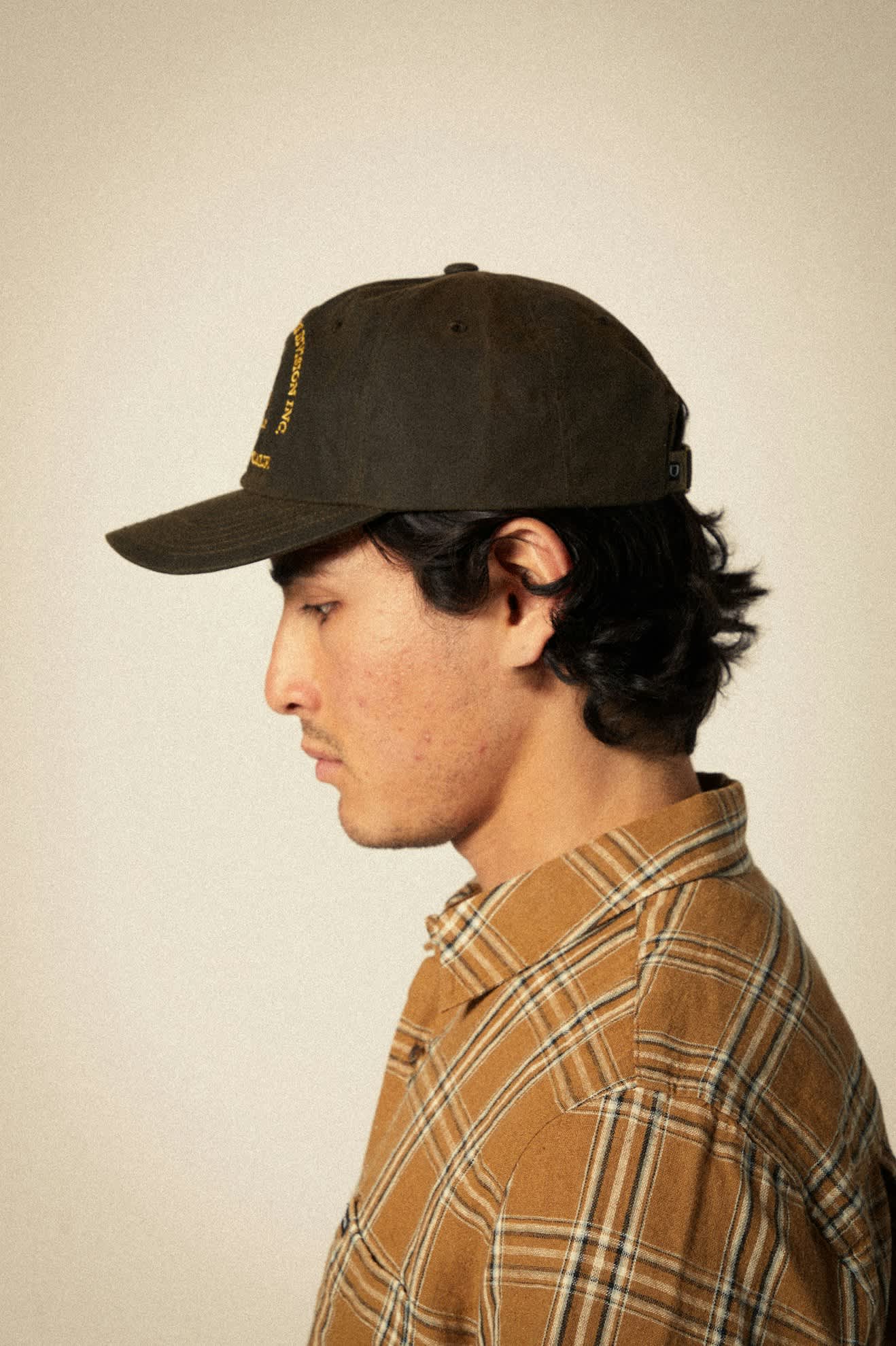 Side view of Brixton Game Weather Cloth Netplus Hat showing curved bill, moss tone, and embroidered wild game design.