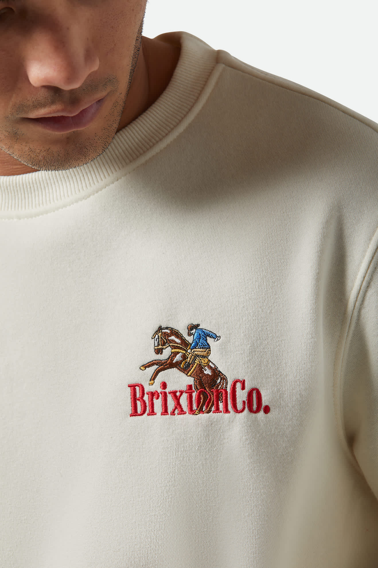 Close-up of left chest embroidery on Brixton Inwood Crew sweatshirt.