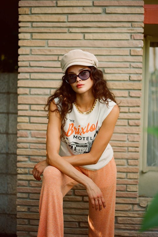 Woman modeling the Brixton Maude Mesh Lounge Pant outside in front of a brick wall.