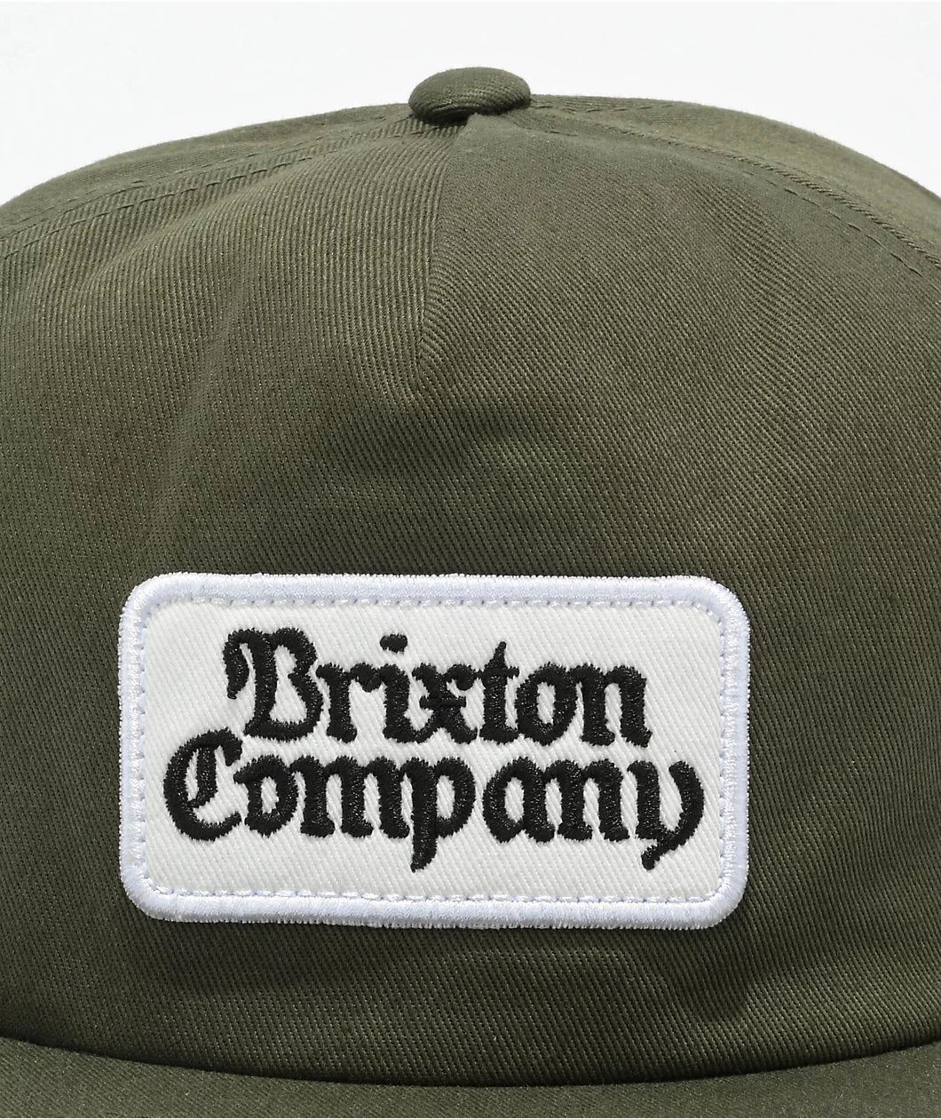 Brixton Norvell Snapback Hat detailed patch on a dark olive snapback. 