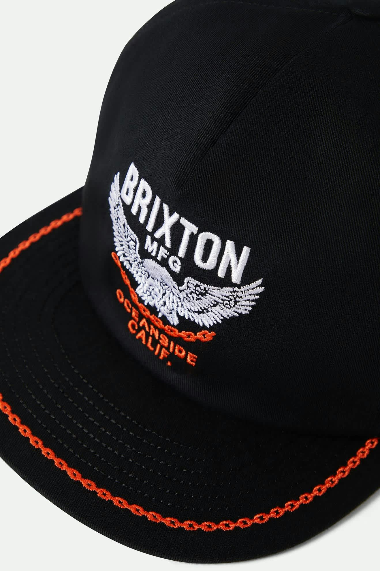 Close-up of embroidery detail on Brixton Waller Snapback flat bill, crafted in durable cotton twill fabric.