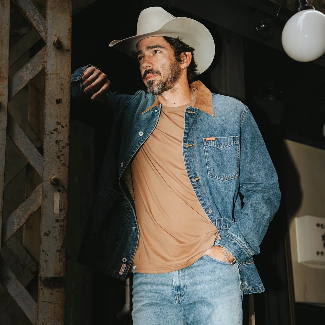 Rustler denim chore coat from Sendero, versatile outerwear with classic western design, cotton liner, and signature hardware.