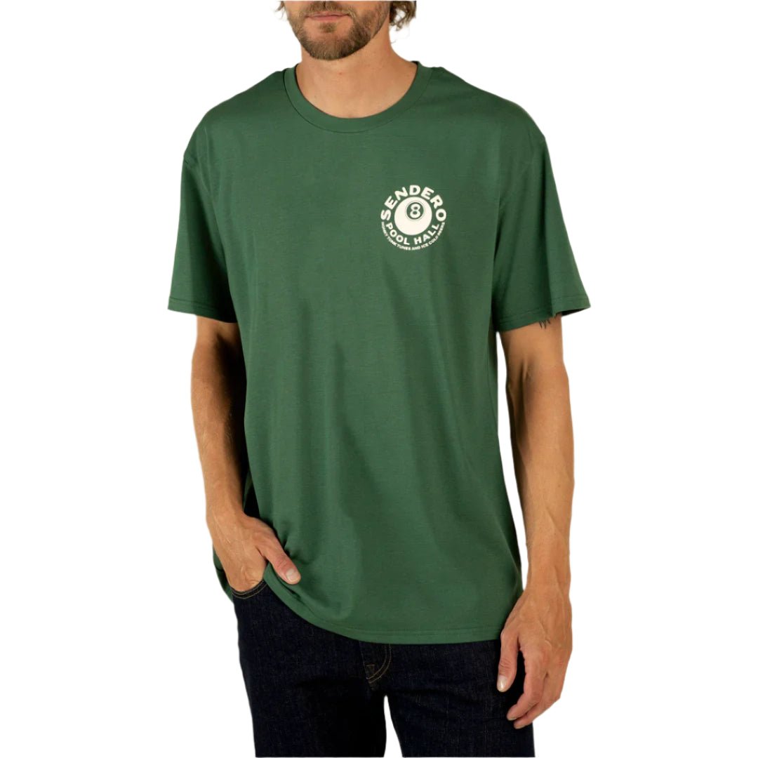 Model wearing Sendero Eightball Vintage Tee in hunter green with soft-touch screen print and relaxed fit.