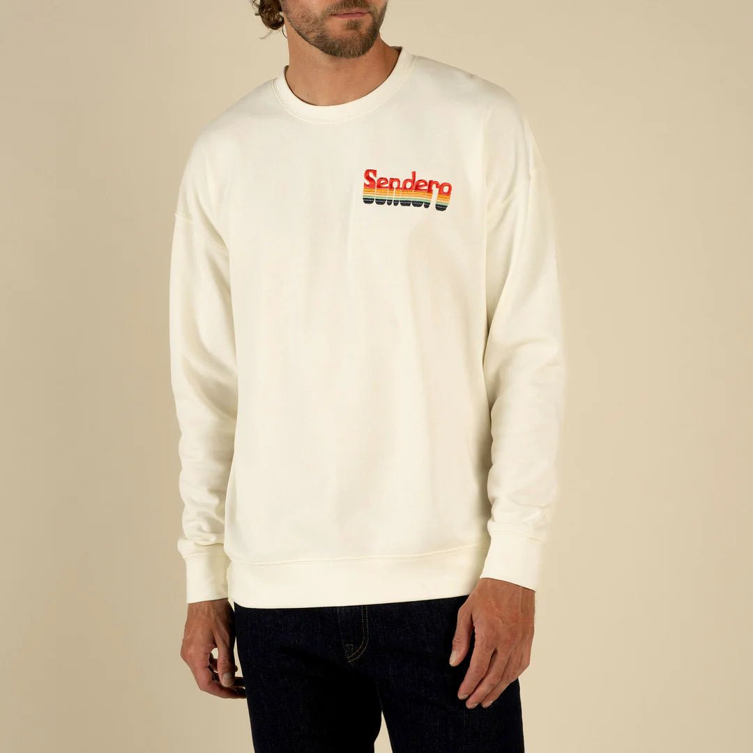 Model wearing Sendero Retro Logo Sweatshirt in vintage white with classic Sendero branding and comfy fit.