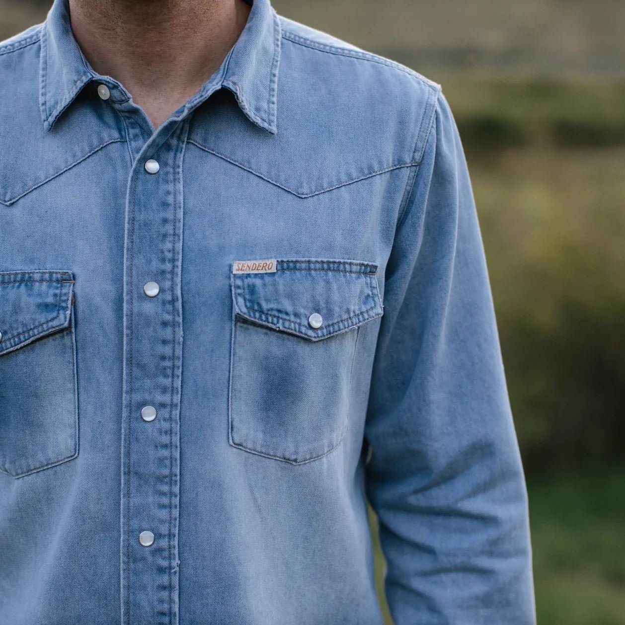 Stone-washed Wyatt Denim Shirt featuring 100% cotton fabric and Sendero western labels.