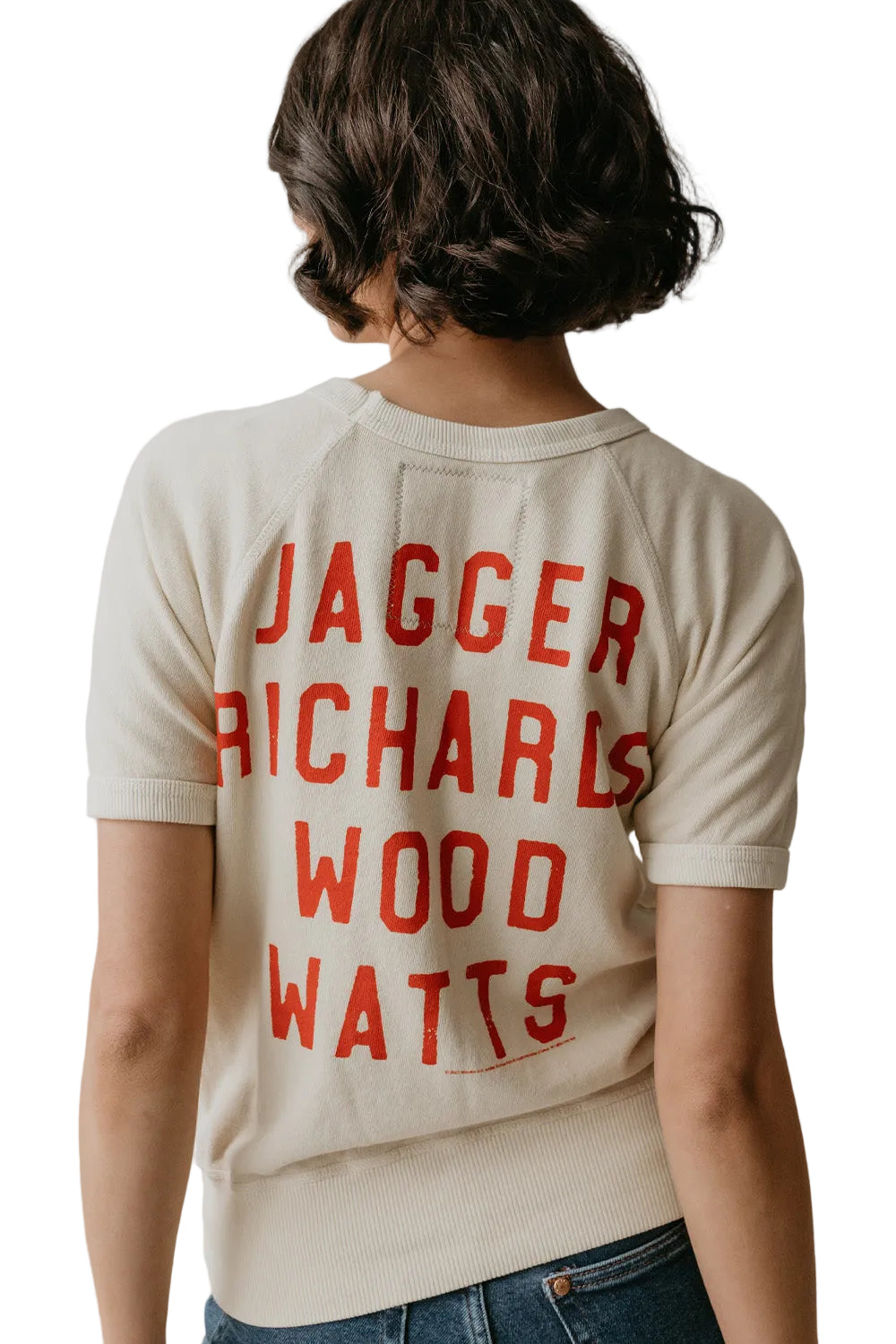 Person wearing a beige shirt with red text on a plain background